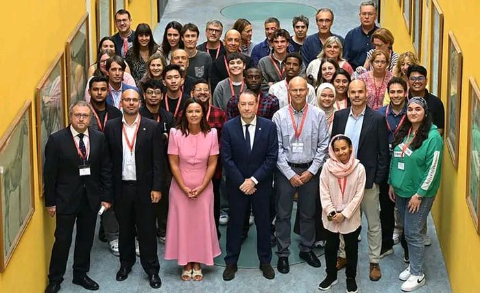 Formal welcome event in a university corridor with staff and students, 2025