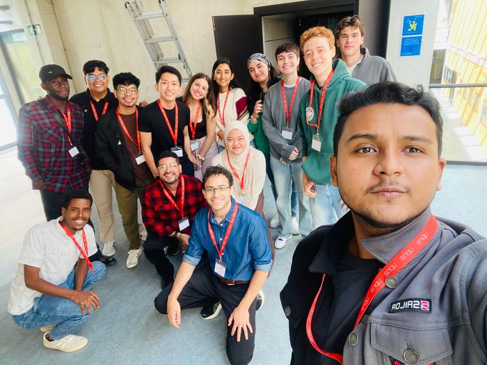 Group selfie with conference lanyards, 2025