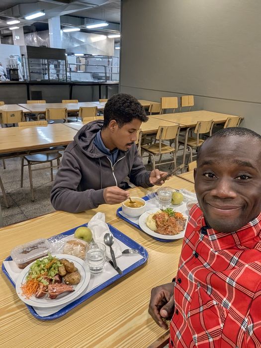 Sharing a meal with a friend in the university cafeteria, 2025